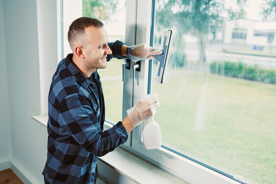 Cleaning windows on a sunny afternoon while enjoying the fresh air and bright light in a cozy indoor space