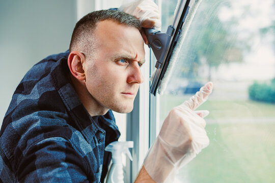 Intense focus during window cleaning in a bright modern home on a sunny day - Powered by Adobe
