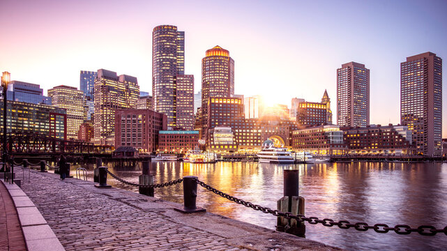 Boston Harbor and Financial District in Boston, Massachusetts, USA at sunset.