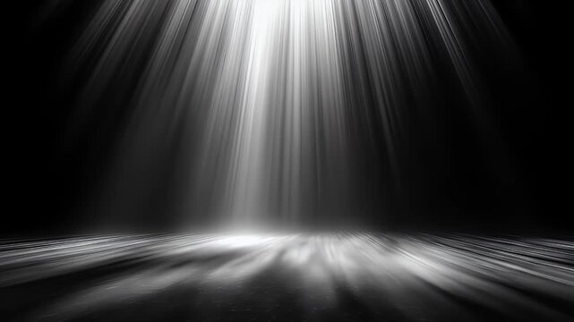 Dramatic spotlight beams illuminate a dark stage floor with atmospheric light rays.