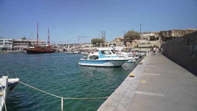 View of boats in Limenas Chersonisou Port on a sunny day, Limenas Chersonisou, Crete, Greek Islands, Greece, Europe