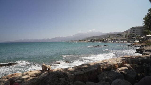 View of beach scene and coastline on a sunny day, Limenas Chersonisou, Crete, Greek Islands, Greece, Europe