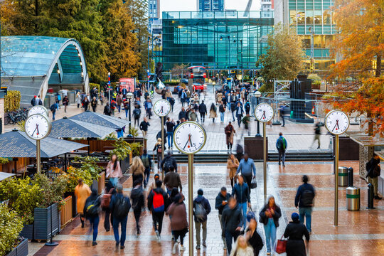 Long exposure view of workers and commuters leaving their offices during rush hour in London at autumn time