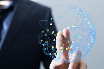 Concept image of a businessman's finger interacting with a digital network globe, representing global connectivity and innovation. Perfect for b