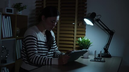 woman working with digital tablet at a night - Powered by Adobe