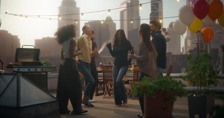 Friends Dance and Laugh Joyfully on a Rooftop, Celebrating a Fun Weekend Party. Happy Young People in Carefree and Good Mood Having Fun Together