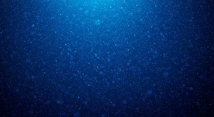 Obraz premium Abstract blue background with small particles illuminated by a light source from above, creating a deep and mysterious underwater effect