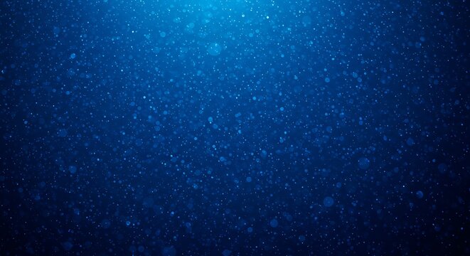 Abstract blue background with small particles illuminated by a light source from above, creating a deep and mysterious underwater effect