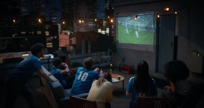 Friends Gather on a Rooftop to Watch a Soccer Football Championship Match. They Enjoy Sports Entertainment, Cheering and Celebrating Teams Championsip Victory. City View Terrace World Tournament Cup
