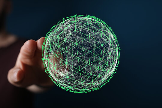 An image of a hand holding a glowing green global network sphere. Represents technology, connection, data, and the future. Perfect for tech and - Powered by Adobe