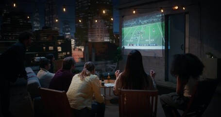 Friends Gather on a Rooftop, Watching Live American Football Match on a Projector. They Enjoy Sports Entertainment, Celebrating Teams Championsip Victory. City View Terrace World Tournament 
