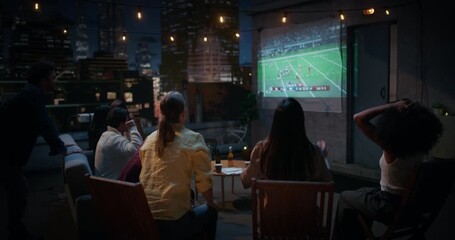 Friends Gather on a Rooftop, Watching Live American Football Match on a Projector. People Disappointed after their Team Loses. - Powered by Adobe