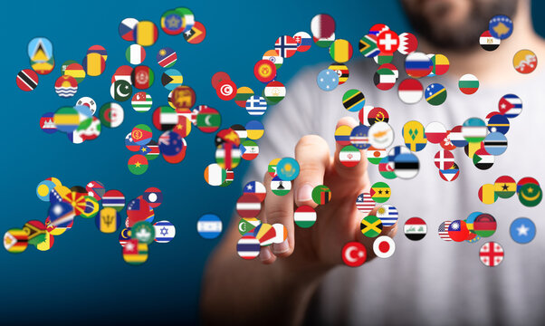 Conceptual image of a hand pointing at a collection of diverse world flags, symbolizing global connections, unity, and international relations i