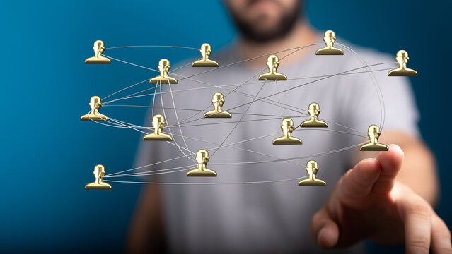 Abstract image of hand touching network of people. Connections, communication, team work and global relations. Business and technology concept.