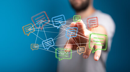 Concept of communication, social media, online chat, digital messaging, and information sharing, with a man's hand interacting with speech bubbl