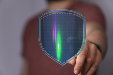 An image of a hand holding a glowing shield, symbolizing digital security, data protection, and...