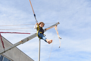 Child playing on a trampoline at an amusement park