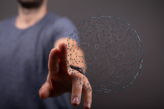 Conceptual image of a man touching a digital sphere, representing global connection, technology, and futuristic concepts. Great for illustrating