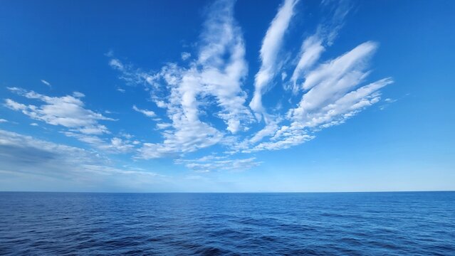Cloudy Blue Sky Over Calm Ocean Water