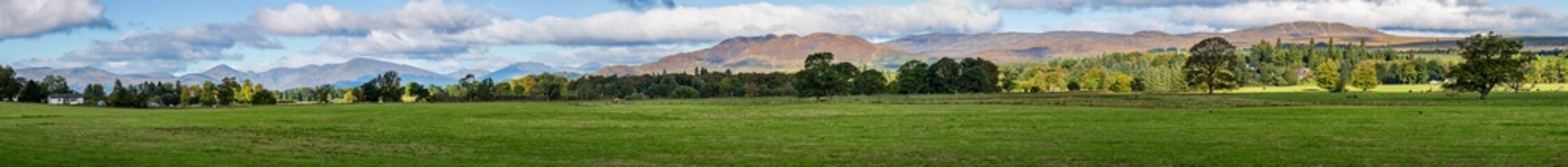 Ultra wide panorama of the Scottish Highlands and villages around Loch Lomond, in autumn. Situated in the Lorn region of the Trossachs National Park, west Scotland.