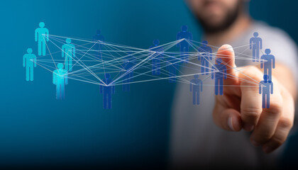 Hand pointing at connected network of people, representing connection, communication, and teamwork...