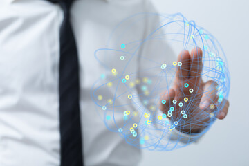 A business professional interacts with a digital network globe, symbolizing global connections and technological advancement in a modern context