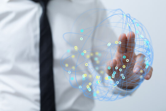 A business professional interacts with a digital network globe, symbolizing global connections and technological advancement in a modern context