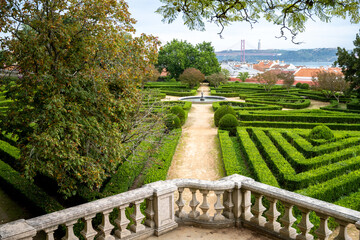 Stone terrace overlooking garden and 25 de Abril Bridge in Belem Lisbon Portugal
