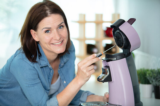 happy woman going to repare coffee machine