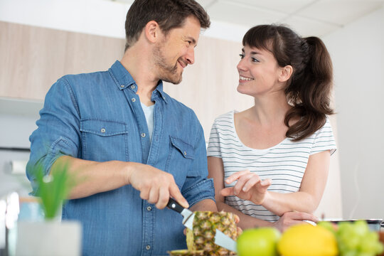 happy young couple cooking together at home