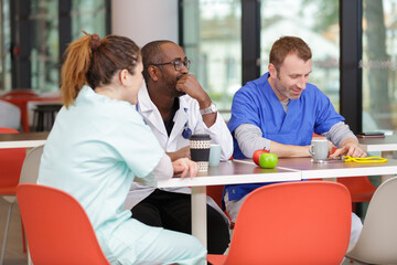 doctors eat as a team in the cafeteria