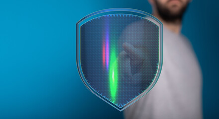 Concept image of a man protecting his data with a digital shield. Represents cyber security, data...