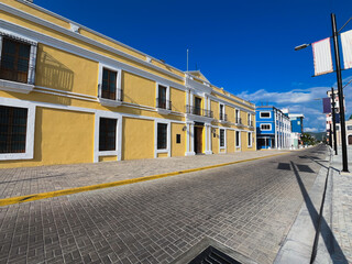 Colonial building of a vibrant yellow color on a cobblestone street under a clear blue sky - Old City Hall of Puerto Cabello, Venezuela