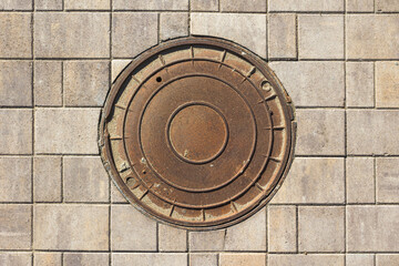 manhole cover on the tiled pavement