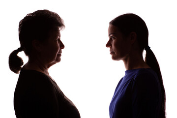 Silhouette elderly woman opposite young woman, mother and daughter - isolate