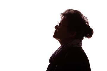 Dark silhouette of an elderly woman, pensioner in glasses - isolate
