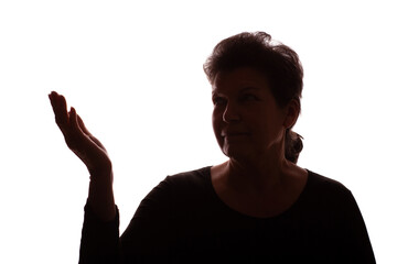 Dark silhouette elderly woman, pensioner points hand to side - isolate