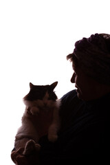 Dark silhouette elderly woman, pensioner with cat in hands - isolate
