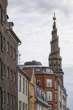 Historic houses, corkscrew-shaped tower of the Evangelical Lutheran Church of the Saviour, in front of Frelsers Kirke, Christianshavn, Copenhagen, Denmark