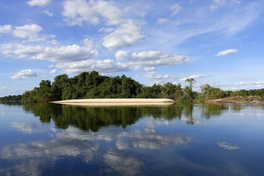 Sky and trees reflecting in the Juruena river, Alta Floresta, Amazon, Brazil