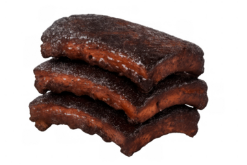 Stacked barbecue pork ribs with crispy bark, smoked and seasoned, ready for a delicious meal on transparent background