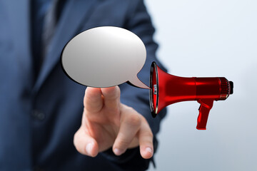 Business communication concept: Businessman using a megaphone with a speech bubble, concept for announcement or marketing