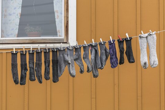 Socks hanging on washing line in front of house, Sisimiut, West Greenland, Greenland