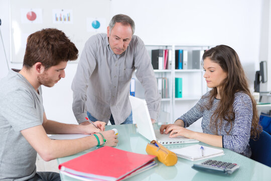 portrait of teacher and financial and accounting interns