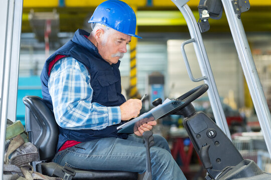 senior worker driving the fork lift