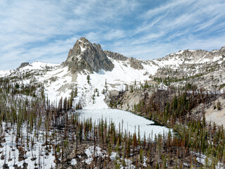 High mountain lake in spring still frozen