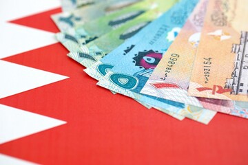 Bahraini dinar currency money bills lies on flag close up. The concept of business and investment