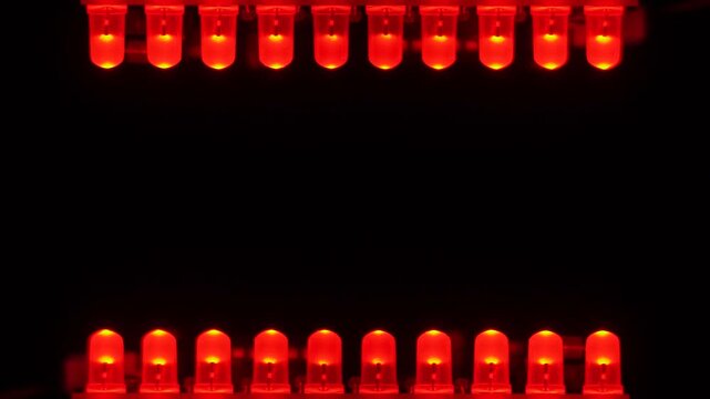 Twin lines of red LEDs glow against a pure black center, creating a tunnel-like frame. Copyspace.