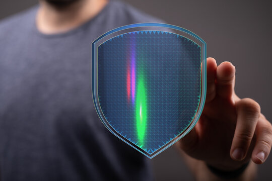 Abstract image of a person touching a digital shield, symbolizing data protection and cyber security measures. Represents safety, pri