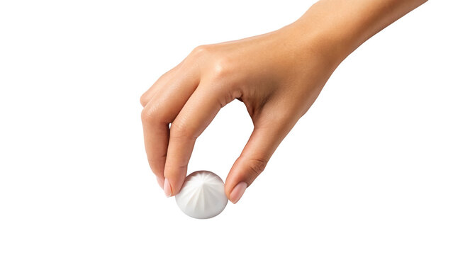 Woman's hand holding a delicate white dessert on a clean backdrop isolated on white background